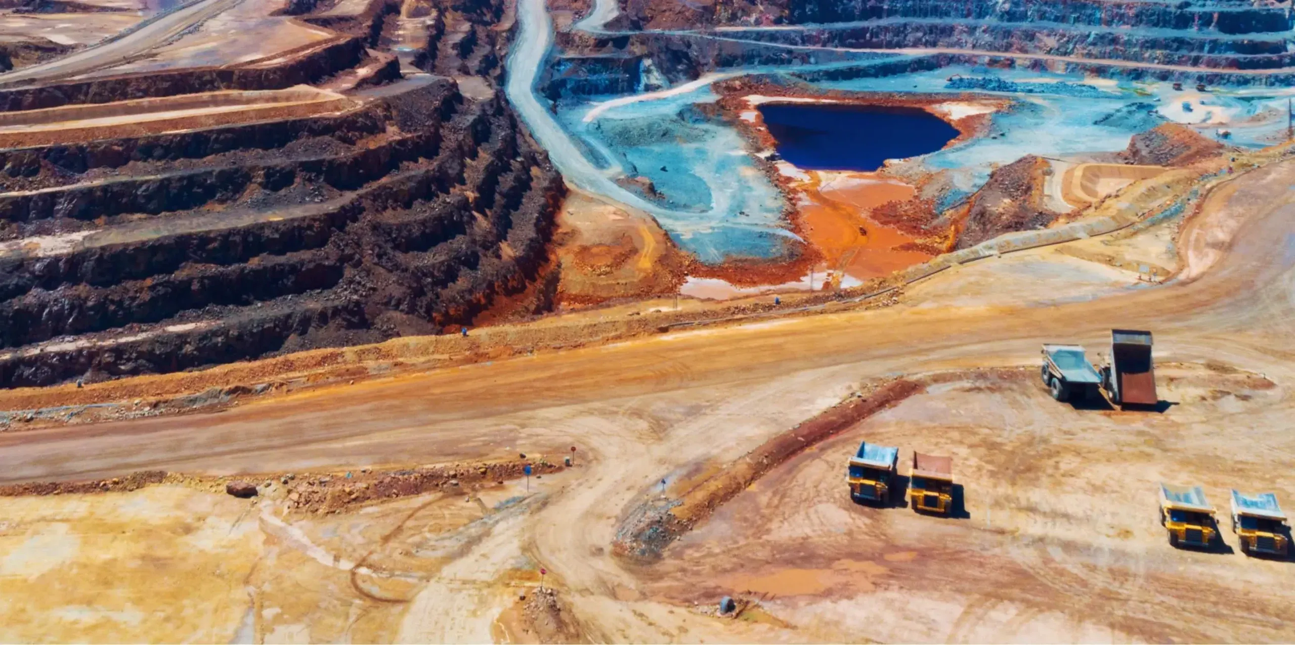 Aerial view of an open-pit mine with haul trucks